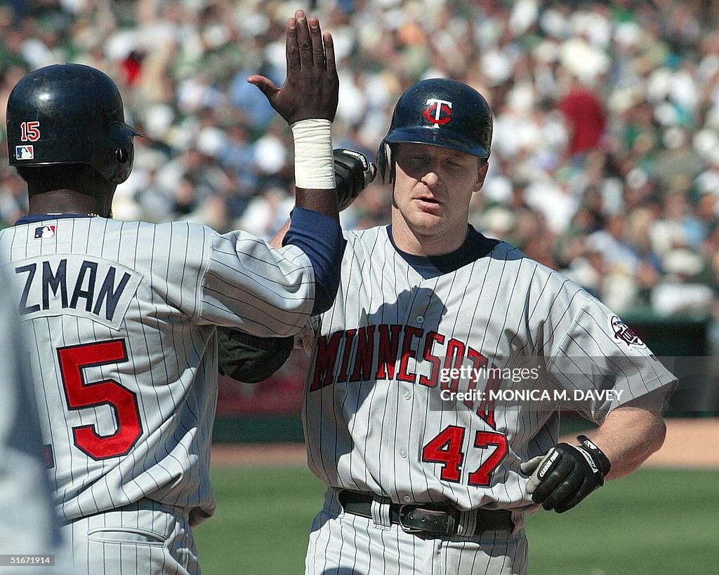Greeted Minnesota Twins' Corey Koskie is greeted at homeplate by teammate ...
