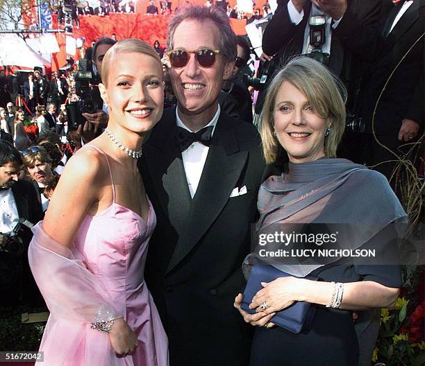 This 21 March 1999 file photo shows US actress Gwyneth Paltrow posing with her father director Bruce Paltrow and mother actress Blythe Danner upon...