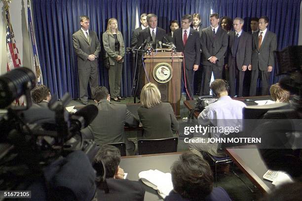 United States Attorney Michael Sullivan , FBI Special Agent Charles Prouty and other investigators speak during a press conference 04 October 2002...