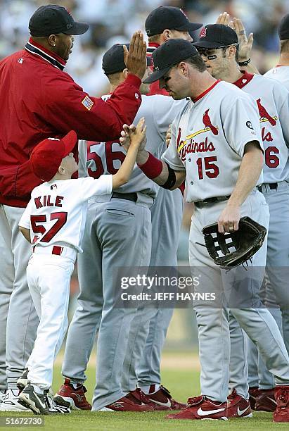 Kannon Kile , son of deceased St. Louis Cardinals pitcher Darryl Kile, gets a high five from Cardinals Jim Edmonds after their victory over the San...