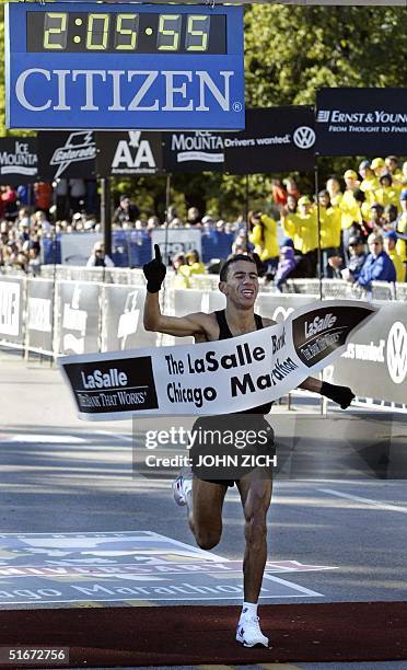 Khalid Khannouchi of the United States crosses the finish line and wins the Chicago Marathon 13 October 2002 with an official time of 2:05:56. The...
