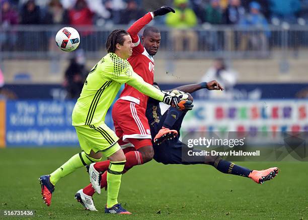 Sapong of Philadelphia Union gets fouled by Jose Goncalves of New England Revolution while taking a shot on goalkeeper Bobby Shuttleworth at Talen...