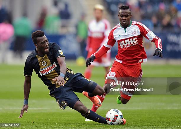 Sapong of Philadelphia Union kicks the ball away from Gershon Koffie of New England Revolution at Talen Energy Stadium on March 20, 2016 in Chester,...