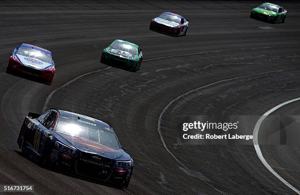 Jimmie Johnson, driver of the Lowe's / Superman Chevrolet, leads a pack of cars during the NASCAR Sprint Cup Series Auto Club 400 at Auto Club...