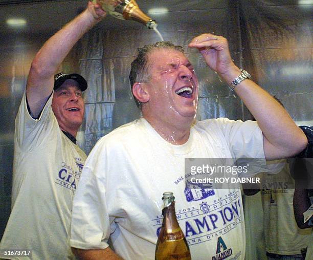Arizona Diamondbacks pitcher Curt Schilling empties a bottle of champagne on Diamondbacks Managing General Partner Jerry Colangelo following their...