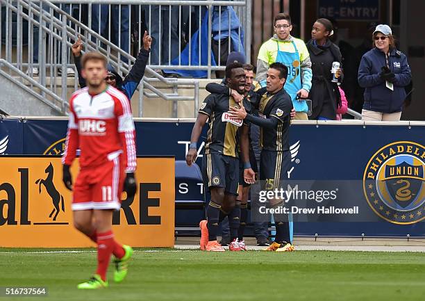 Sapong of Philadelphia Union is congratulated by teammates Chris Pontius and Ilsinho as Kelyn Rowe of New England Revolution walks away at Talen...