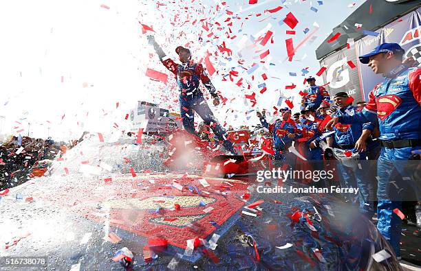 Jimmie Johnson, driver of the Lowe's / Superman Chevrolet, celebrates in victory lane after winning the NASCAR Sprint Cup Series Auto Club 400 at...