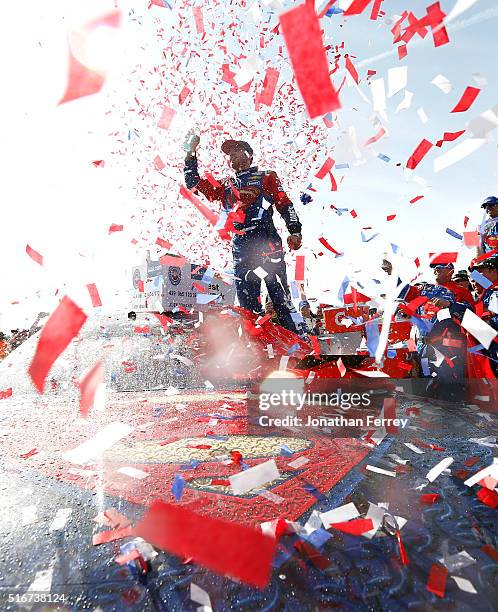 Jimmie Johnson, driver of the Lowe's / Superman Chevrolet, celebrates in victory lane after winning the NASCAR Sprint Cup Series Auto Club 400 at...