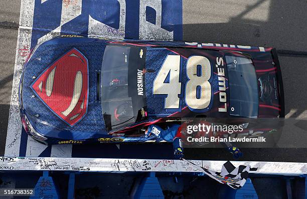 Jimmie Johnson, driver of the Lowe's / Superman Chevrolet, celebrates after taking the checkered flag during the NASCAR Sprint Cup Series Auto Club...