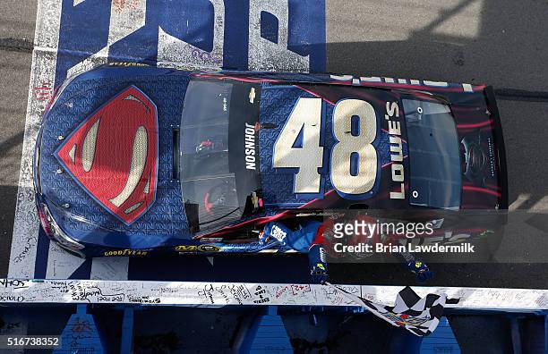 Jimmie Johnson, driver of the Lowe's / Superman Chevrolet, celebrates after taking the checkered flag during the NASCAR Sprint Cup Series Auto Club...