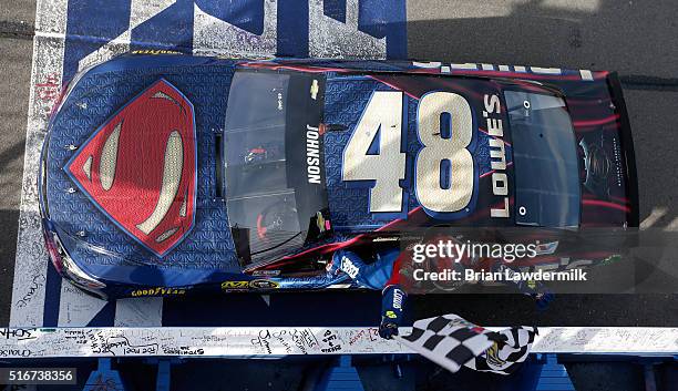 Jimmie Johnson, driver of the Lowe's / Superman Chevrolet, celebrates after taking the checkered flag during the NASCAR Sprint Cup Series Auto Club...