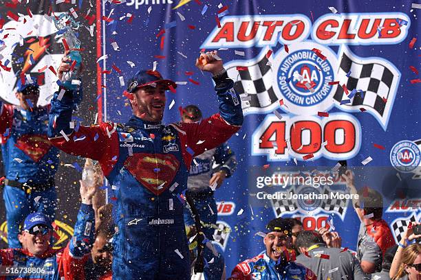 Jimmie Johnson, driver of the Lowe's / Superman Chevrolet, celebrates in victory lane after winning the NASCAR Sprint Cup Series Auto Club 400 at...