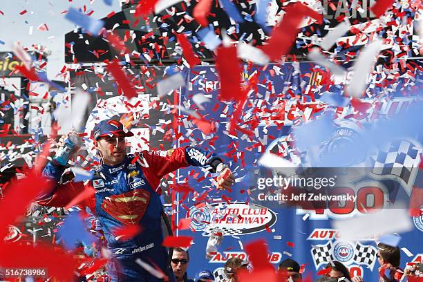 Jimmie Johnson, driver of the Lowe's / Superman Chevrolet, celebrates in victory lane after winning the NASCAR Sprint Cup Series Auto Club 400 at...