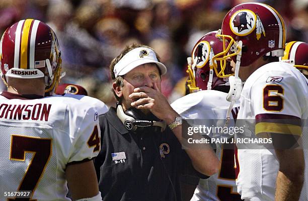 Washington Redskins new Head Coach Steve Spurrier meets with his players during a time out during first half NFL action in the home opening game...