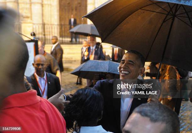 President Barack Obama talks to tourists and Cubans at his arrival to the Havana Cathedral, on March 20, 2016. On Sunday, Obama became the first US...