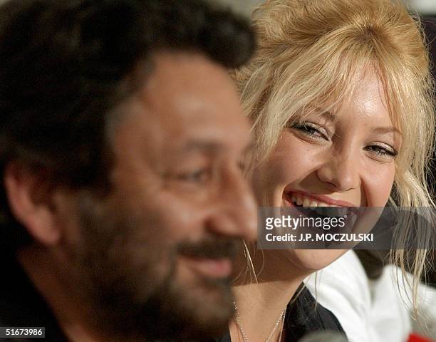 Indian director Shekhar Kapur laughs with US actress Kate Hudson while discussing the making of his new film "The Four Feathers" during a news...