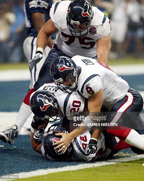The Houston Texans Billy Miller celebrates with teammates James Allen , David Carr and Jimmy Herndon after scoring the team's first ever touchdown...