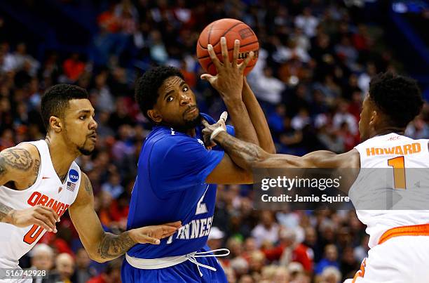 Perrin Buford of the Middle Tennessee Blue Raiders handles the ball between Michael Gbinije and Franklin Howard of the Syracuse Orange in the second...