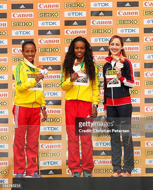 Silver medallist Meseret Defar of Ethiopia, gold medallist Genzebe Dibaba of Ethiopia and bronze medallist Shannon Rowbury of the United States...
