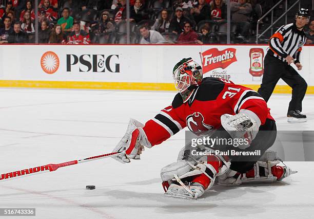 Goalie Scott Wedgewood of the New Jersey Devils stops a breakaway shot late in the third period to preserve the win in his first NHL hockey game at...
