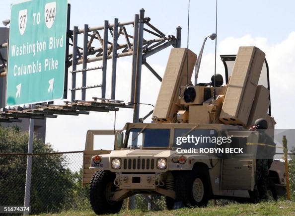 Humve Rocket Military personnel manning a humvee mounted with a rocket launcher ...