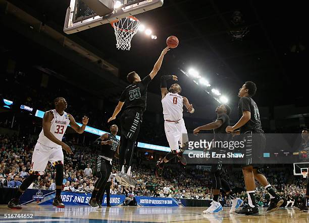 Stefan Jankovic of the Hawaii Warriors defends the net against Rasheed Sulaimon of the Maryland Terrapins in the second half during the second round...