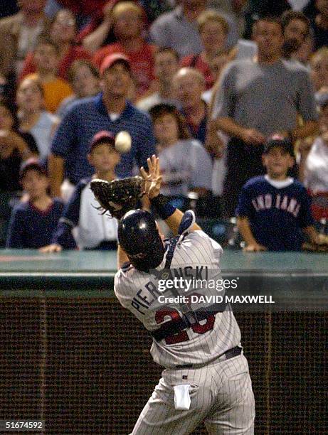 Clevelanad Indian fans watch as Minnesota Twin catcher A. J. Pierzynski catches the ball hit by Cleveland Indian batter John McDonald for the first...