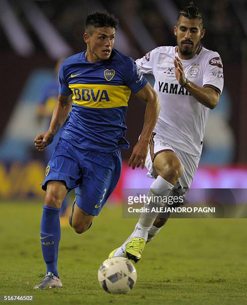 Boca Juniors's defender Jonathan Silva vies for the ball with Lanus' midfielder Oscar Benitez during their Argentina First Division football match at...