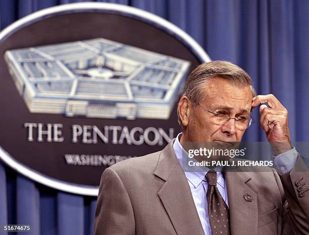 Secretary of Defense Donald Rumsfeld pauses as he briefs reporters on developments on the war on terrorism and developments with Iraqi leader Saddam...