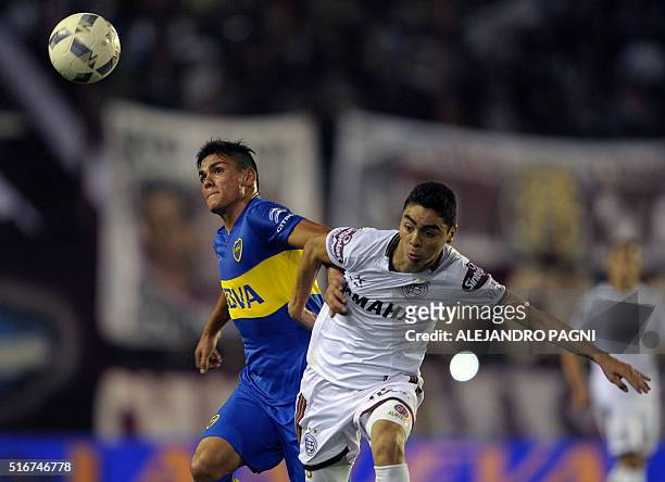 Boca Juniors's defender Jonathan Silva vies for the ball with Lanus' midfielder Miguel Almiron during their Argentina First Division football match...
