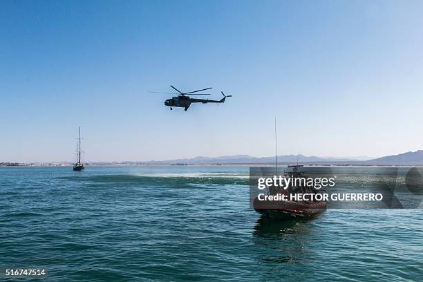 Mexican Navy helicopter and boats patrol the Cortes Sea in San Felipe, Baja California State, Mexico on March 17, 2016. The Mexican Navy is carrying...