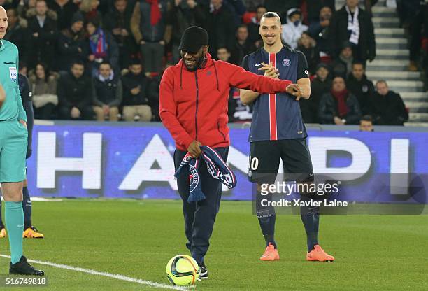 Jay-Jay Okocha kickoff the game during the French Ligue 1 match between Paris Saint-Germain and AS Monaco at Parc des Princes on march 20, 2016 in...