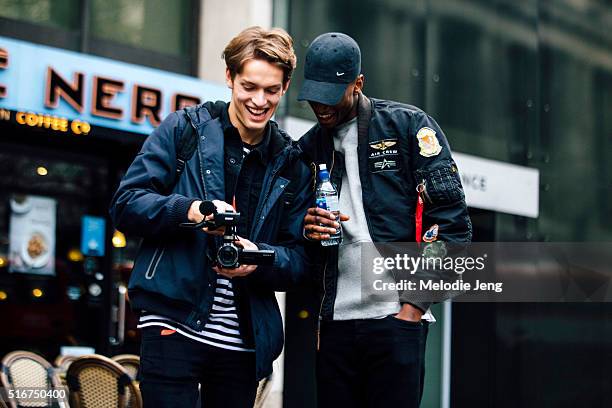 Models Oskar Tranum and Oliver Kumbi film the crowd after the E. Tautz during The London Collections Men AW16 at The Strand on January 08, 2016 in...