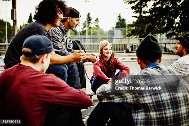 skateboarders sitting in discussion in skate park - adult helping teenager stock pictures, royalty-free photos & images