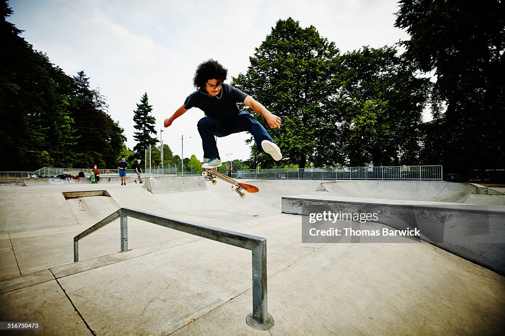 Male skateboarder in mid air in skate park