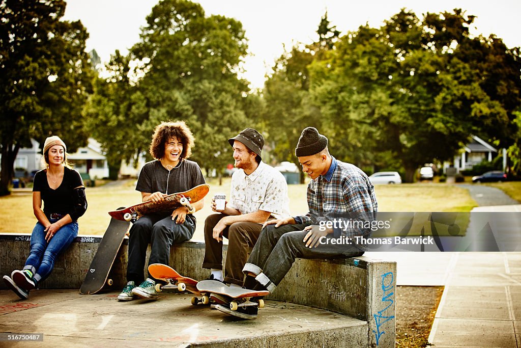 Skateboarders hanging out in skate park