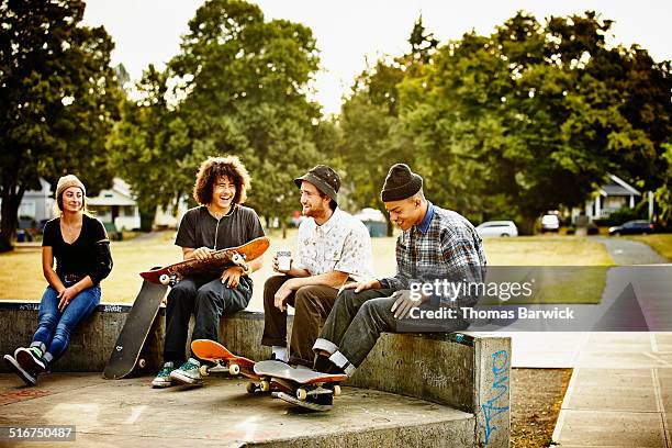 skateboarders hanging out in skate park - friends sitting skate park stock pictures, royalty-free photos & images