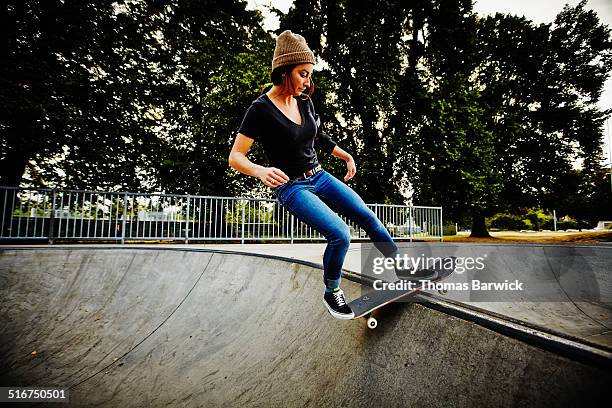 female skateboarder riding in skate park - lean in collection stock pictures, royalty-free photos & images