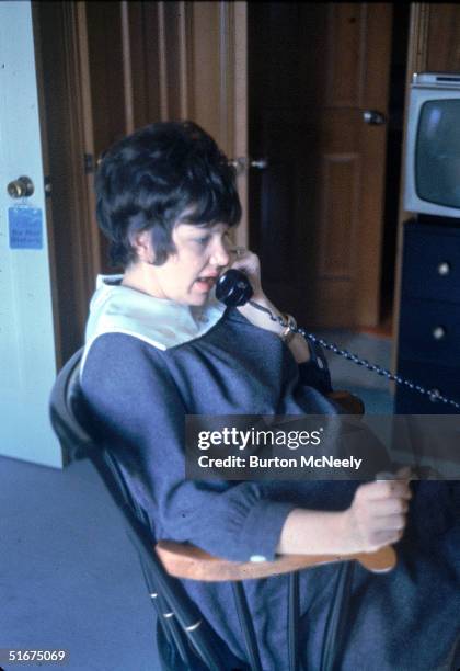 Marilyn Lovell, wife of Gemini 7 astronaut Jim Lovell, talks on the telephone while she sits in a rocking chair on the day of her husband's space...