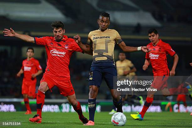 Fidel Martinez of Pumas struggles for the ball with Facundo Erpen of Morelia during the 11th round match between Pumas UNAM and Morelia as part of...