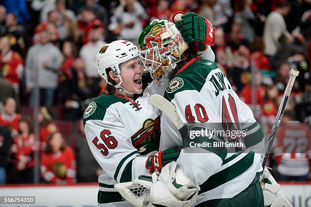 Erik Haula and goalie Devan Dubnyk of the Minnesota Wild celebrate after defeating the Chicago Blackhawks 3 to 2 in a shoot-out during the NHL game...