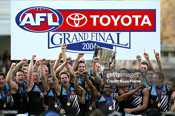 Port Adelaide celebrate with the premiership trophy after the AFL Grand Final between the Port Adelaide Power and the Brisbane Lions at the Melbourne...