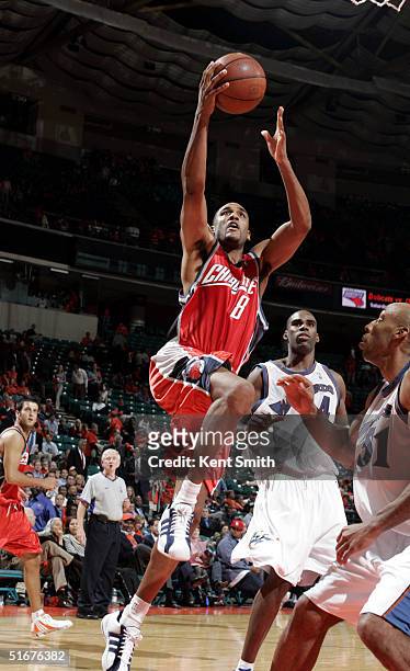 Steve Smith of the Charlotte Bobcats shoots over Michael Ruffin the Washington Wizards during the game on November 4, 2004 at the Charlotte Coliseum...