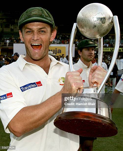 Adam Gilchrist of Australia celebrates with the Border Gavaskar Trophy after winning the series 2 - 1 with team mate Ricky Ponting looking on after...