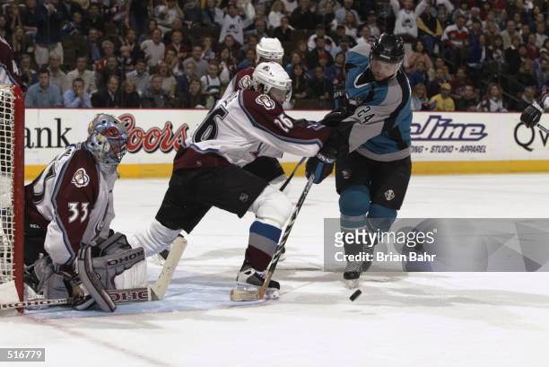 Goalie Patrick Roy and Stephane Yelle of the Colorado Avalanche prevent Niklas Sundstrom of the San Jose Sharks from getting a shot on goal in the...