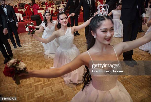 Chinese and foreign debutantes dance during the Vienna Ball at the Kempinski Hotel on March 19, 2016 in Beijing, China. The ball, which is an event...