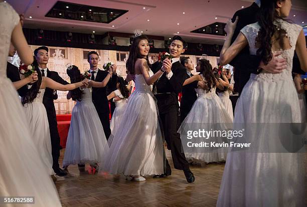 Chinese and foreign debutantes dance during the Vienna Ball at the Kempinski Hotel on March 19, 2016 in Beijing, China. The ball, which is an event...