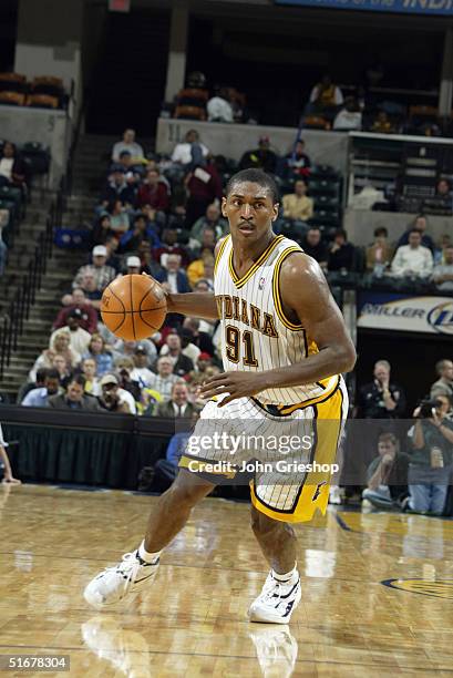 Ron Artest of the Indiana Pacers moves the ball during the preseason game with the Memphis Grizzlies on October 26, 2004 at Conseco Fieldhouse in...