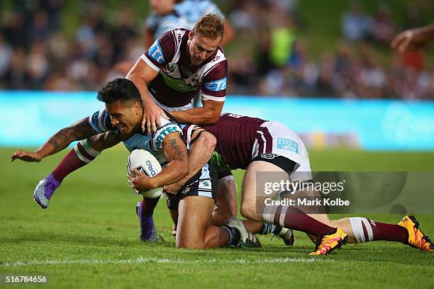 Valentine Holmes of the Sharks is tackled during the round three NRL match between the Manly Sea Eagles and the Cronulla Sharks at Brookvale Oval on...