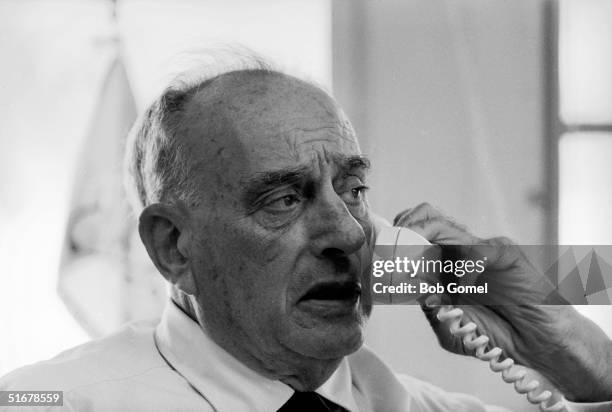 American public official and city planner Robert Moses speaks on the phone in his office, New York, New York, August 1962.